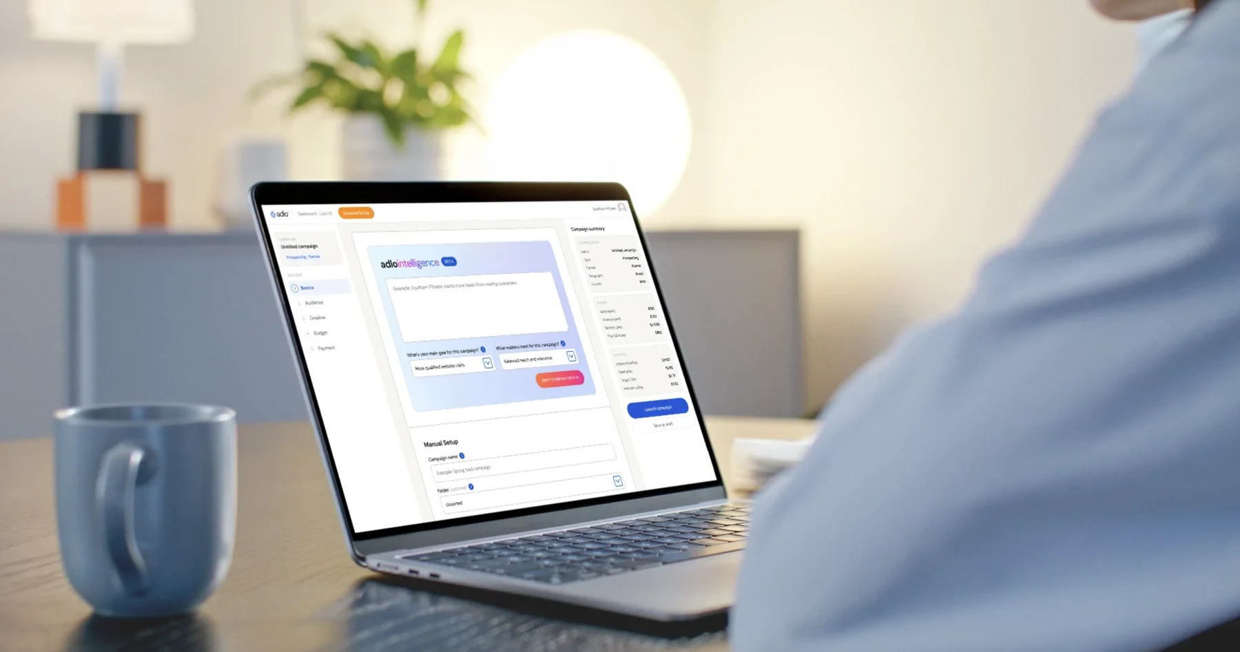 Adlo campaign builder open on a laptop, showing campaign setup and budget summary.